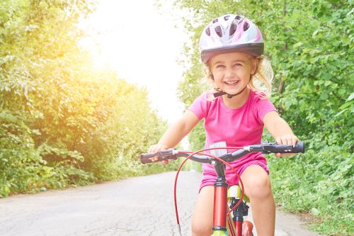 Happy Child Riding A Bike