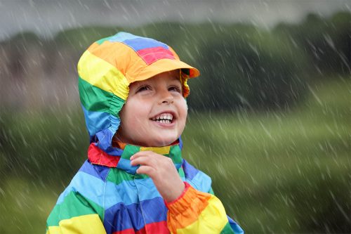 Little boy enjoying the rain